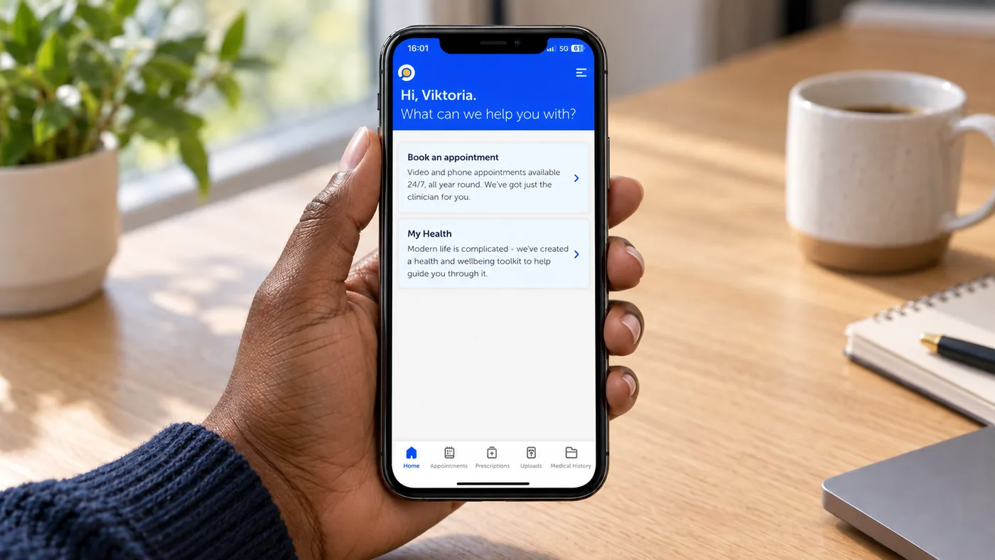 An employee holding a phone showing the health app's home screen